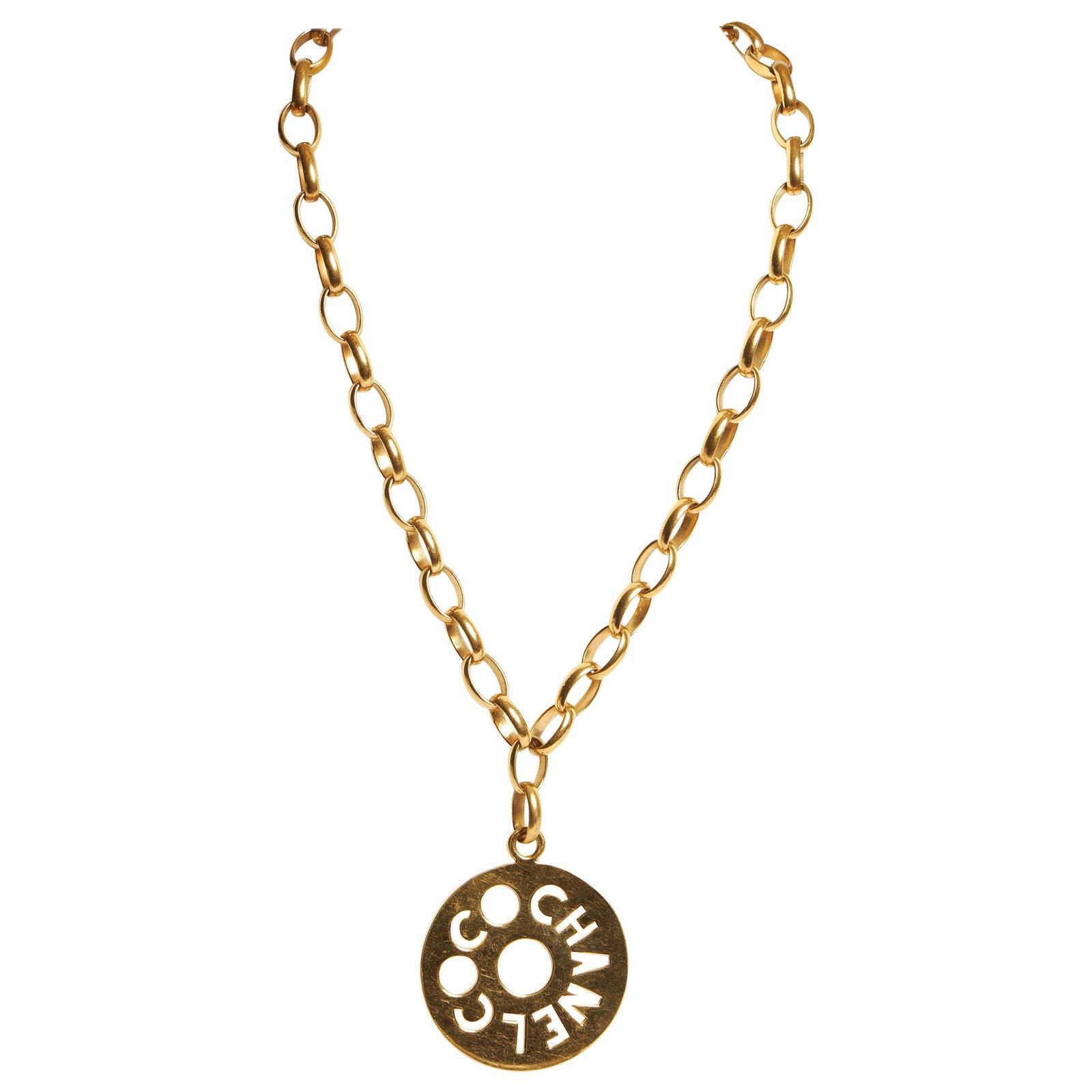 Chanel 70s Oversized COCO Pendant Necklace Belt France: Chanel 70s Oversized COCO Pendant Necklace Belt France This stunning Chanel oversized pendant from the 1970s features the iconic "COCO CHANEL" design, making it a timeless accessory. With versatile st