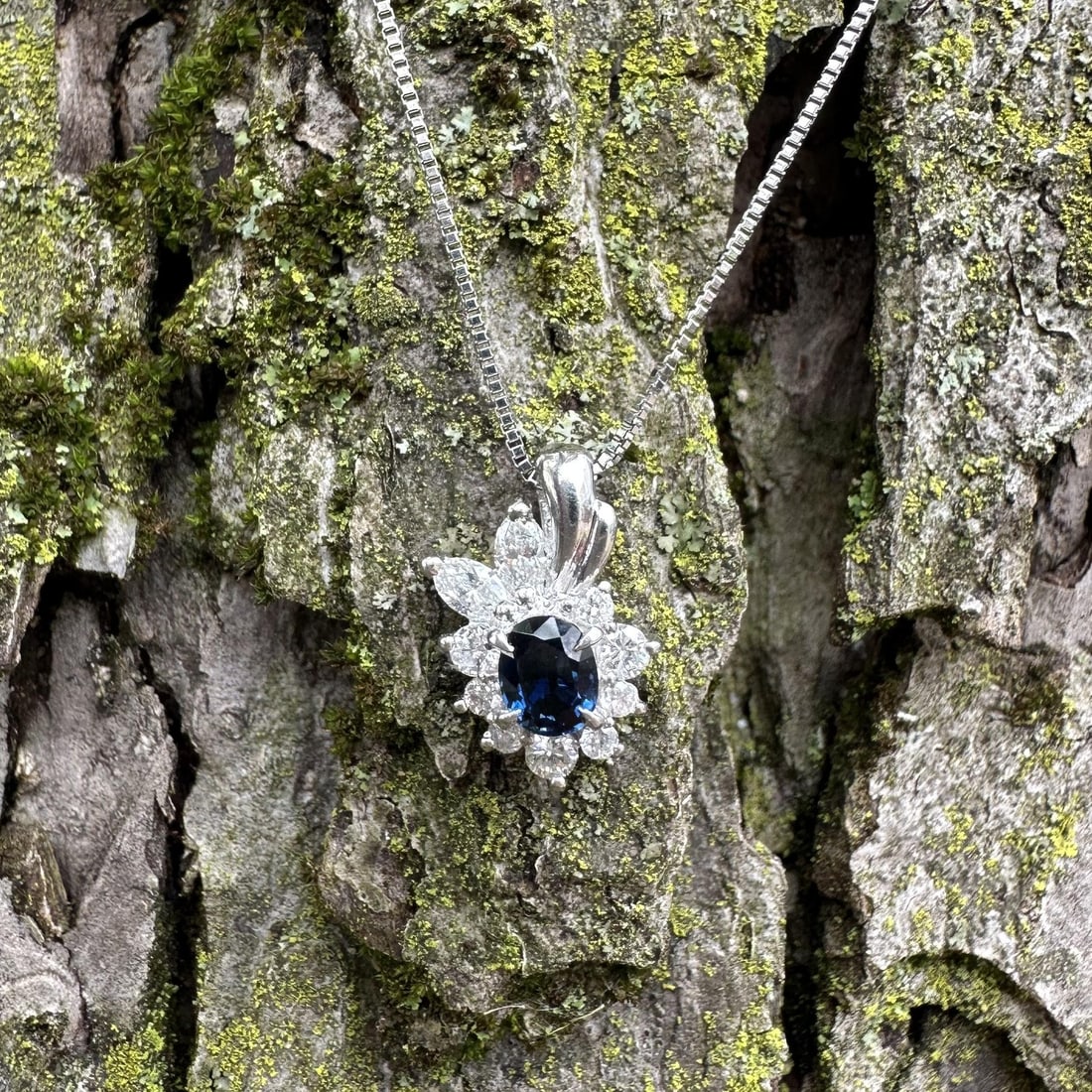 Platinum star sapphire pendant with 10 diamonds on adjustable box chain: Platinum star sapphire pendant with 10 diamonds on adjustable box chain This vintage pendant necklace features an oval, deep blue natural star sapphire set in solid platinum, accented by a spray of te