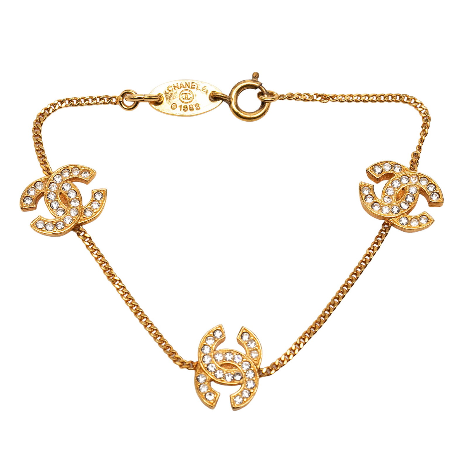 Chanel Triple CC Strass Gold Plated Bracelet: Chanel Triple CC Strass Gold Plated Bracelet Chanel Triple CC Gold Plated Strass Bracelet in gold plated metal with rhinestone embellishments and a spring ring closure. Made in France, this costume je