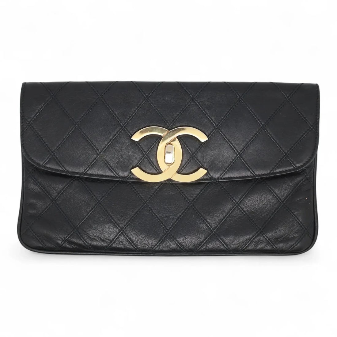Black Quilted Lambskin Leather Envelope Wallet Clutch with CC Turnlock by Chanel: Black Quilted Lambskin Leather Envelope Wallet Clutch with CC Turnlock by Chanel This vintage Chanel envelope clutch is crafted from black lambskin leather with a classic quilted pattern. It features 