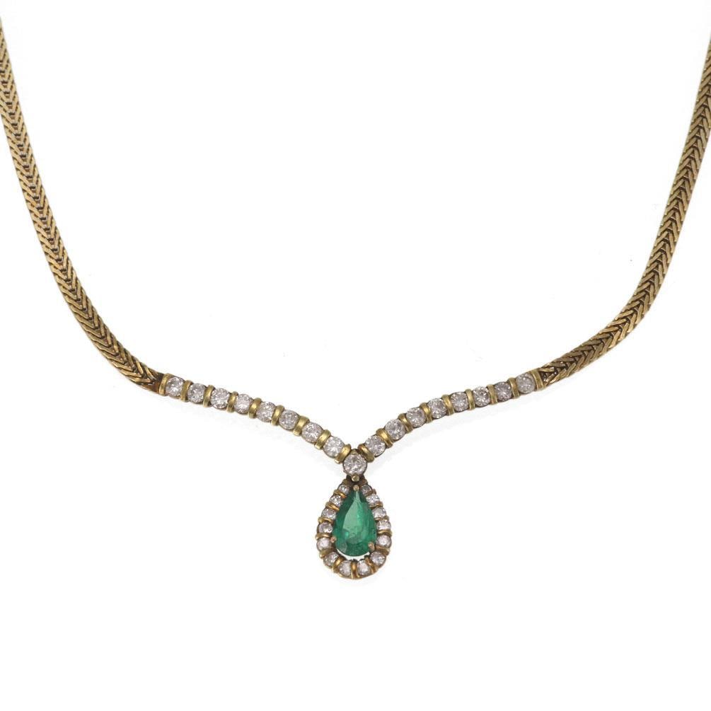 14k Yellow Gold Teardrop Emerald Diamond Necklace: 14k Yellow Gold Teardrop Emerald Diamond Necklace This vintage necklace features a teardrop centerpiece crafted in 14k yellow gold. The design includes a fishbone link chain attached to a V-shaped cen