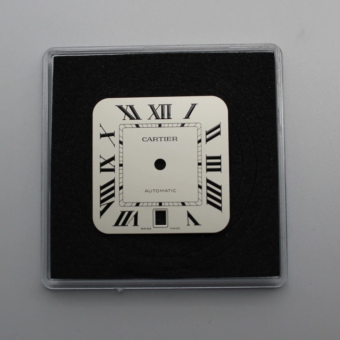 Silvered Opaline Dial for Santos de Cartier Large Model Watch: Silvered Opaline Dial for Santos de Cartier Large Model Watch This is a pre-owned Cartier Santos de Cartier large model watch dial featuring a silvered opaline finish. The dial is designed for men's w