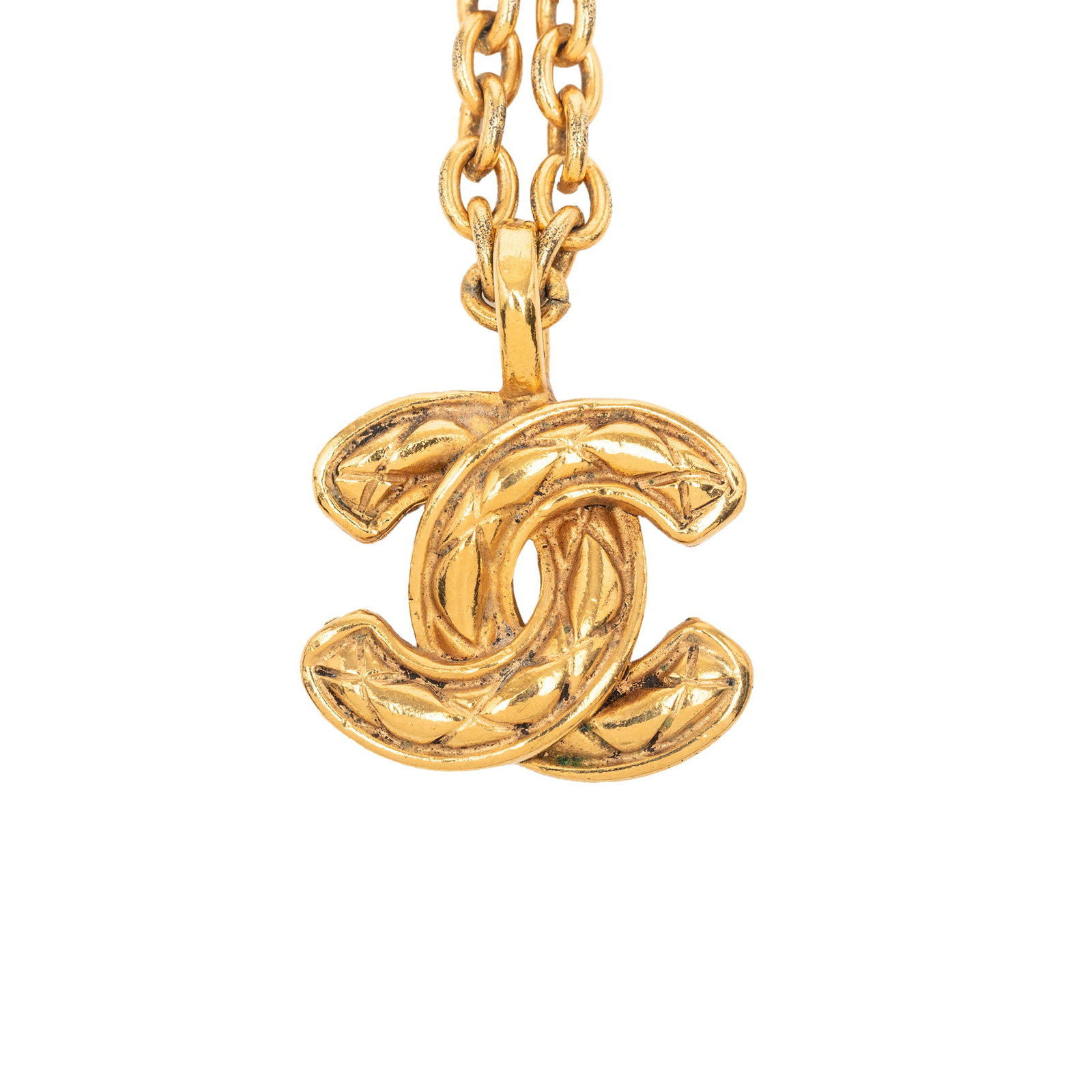 Chanel Quilted CC Logo Gold Plated Pendant Necklace: Chanel Quilted CC Logo Gold Plated Pendant Necklace This Chanel necklace features a gold-plated metal chain with a signature quilted CC pendant and a spring ring closure. The piece is categorized as c