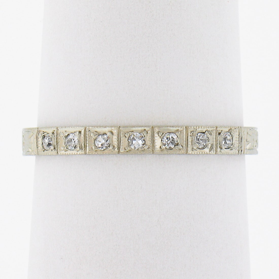 Antique 18K White Gold Pave Diamond Stack Band Ring 0.08ctw: Antique 18K White Gold Pave Diamond Stack Band Ring 0.08ctw This exquisite antique stack band ring is crafted from solid 18K white gold and features a stunning pave diamond design. Adorned with seven 