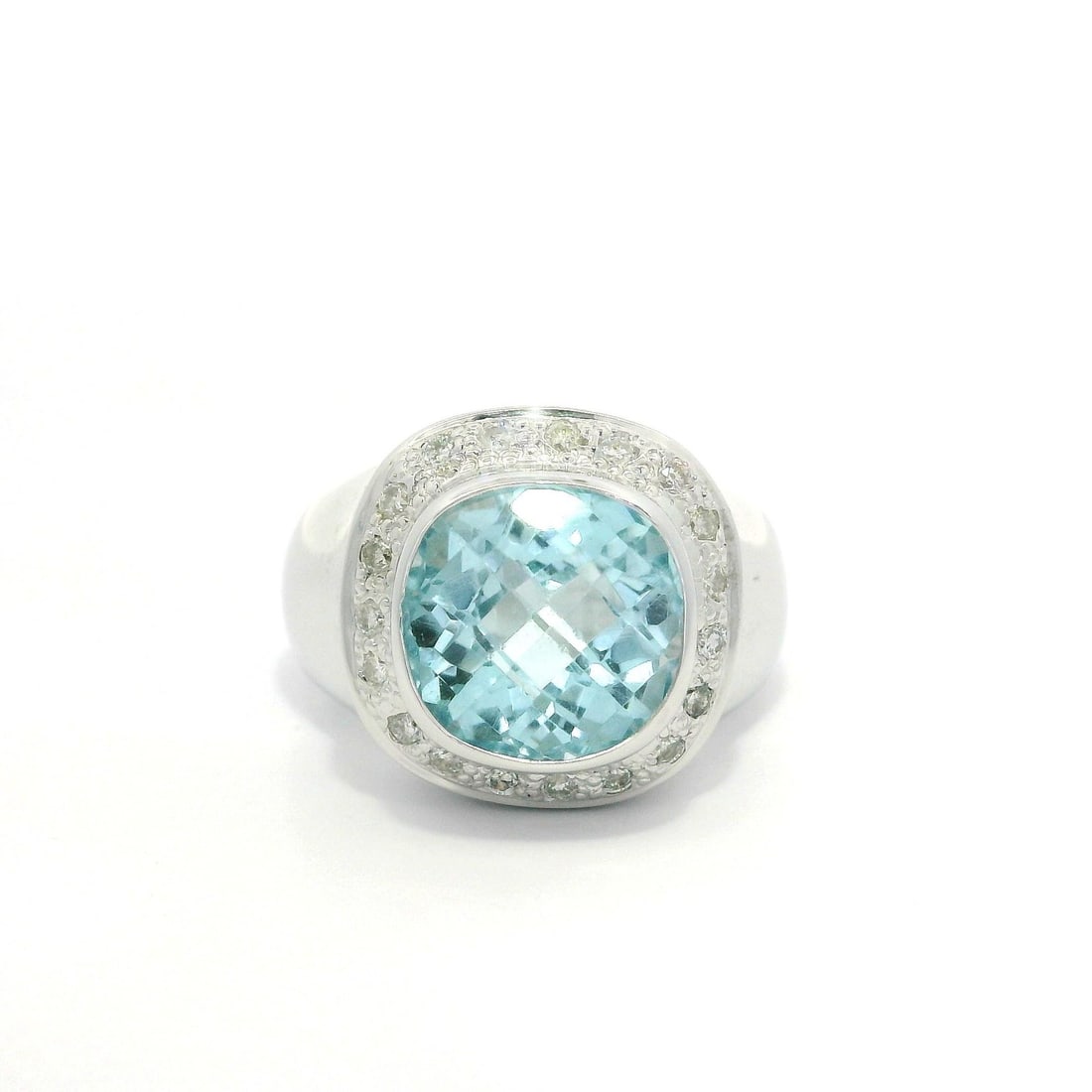 14k White Gold GIA Certified Cushion Blue Topaz & Diamond Ring: 14k White Gold GIA Certified Cushion Blue Topaz & Diamond Ring This stunning 14k white gold ring features a beautiful cushion checkerboard bezel-set blue topaz, complemented by a pave setting of natur