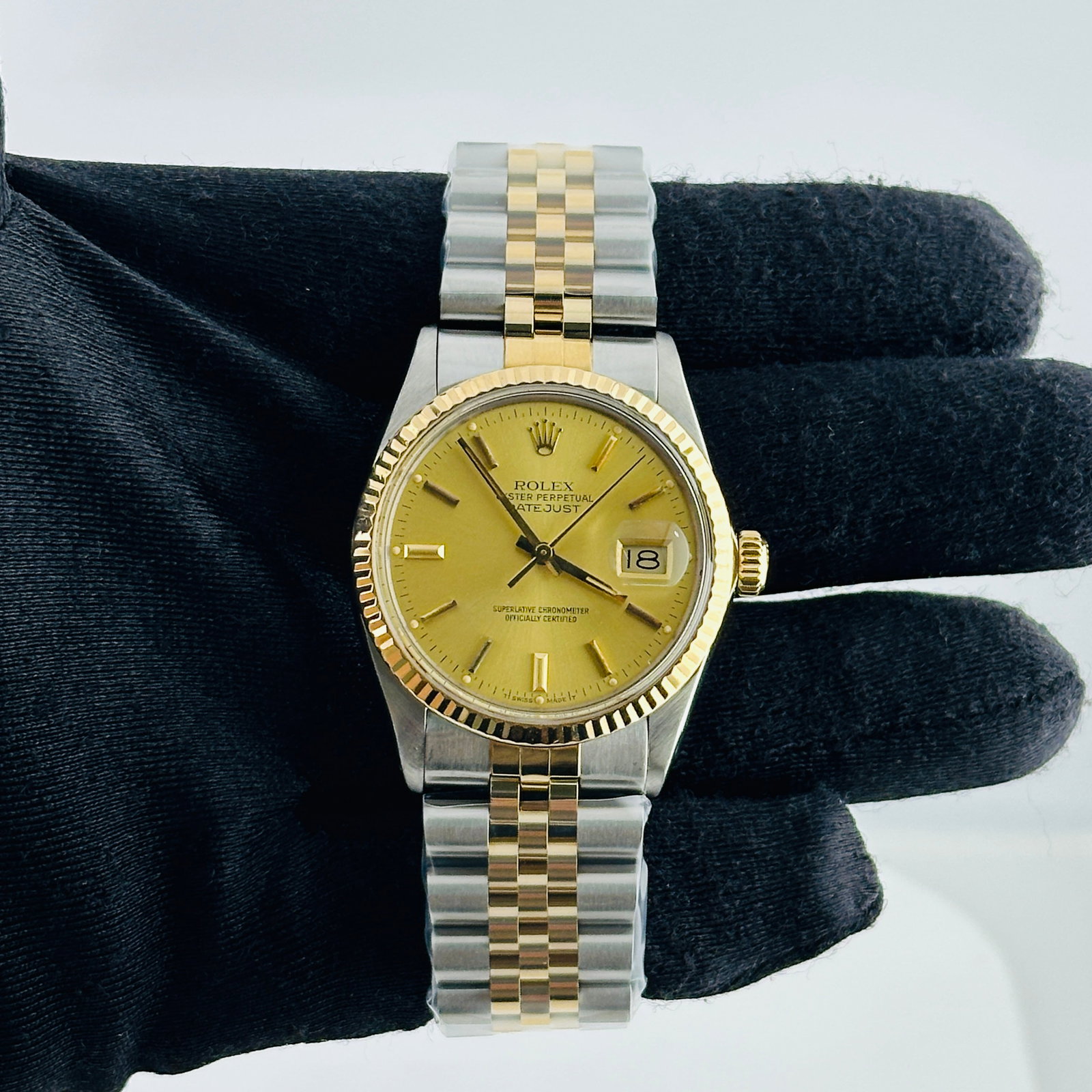 Rolex Datejust 16013 Champagne Stick Dial Fluted Bezel Aftermarket Jubilee Bracelet: Rolex Datejust 16013 Champagne Stick Dial Fluted Bezel Aftermarket Jubilee Bracelet This is a men's Rolex Datejust featuring a champagne stick dial and a fluted bezel. The watch is paired with an afte