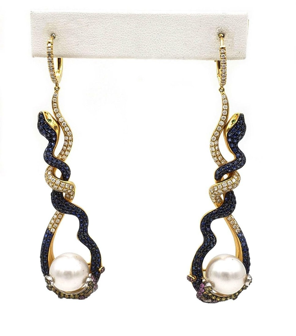 18k Gold Diamond Sapphire South Sea Pearl Long Dangle Snake Earrings: 18k Gold Diamond Sapphire South Sea Pearl Long Dangle Snake Earrings Elevate your elegance with these exquisite long dangle earrings, crafted from luxurious 18k yellow gold. Each earring features a sm