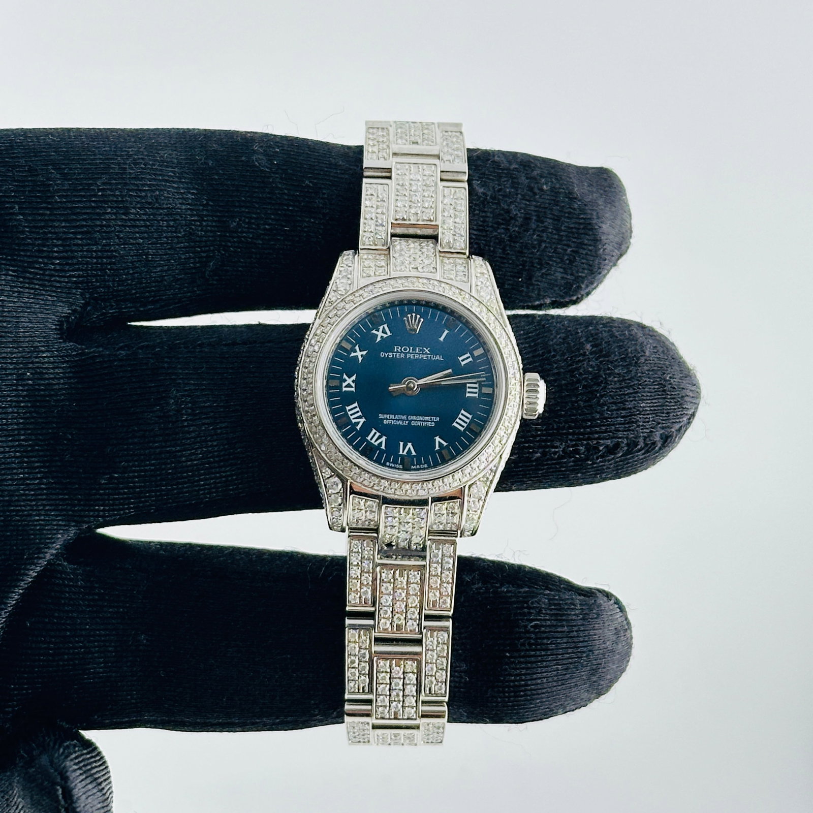 Rolex Oyster Perpetual 176200 Ladies Watch Blue Roman Dial aftermarket: Rolex Oyster Perpetual 176200 Ladies Watch Blue Roman Dial aftermarket Ladies Rolex Oyster Perpetual watch, reference 176200, featuring a blue Roman dial, diamond bezel, and iced out Oyster bracelet. 