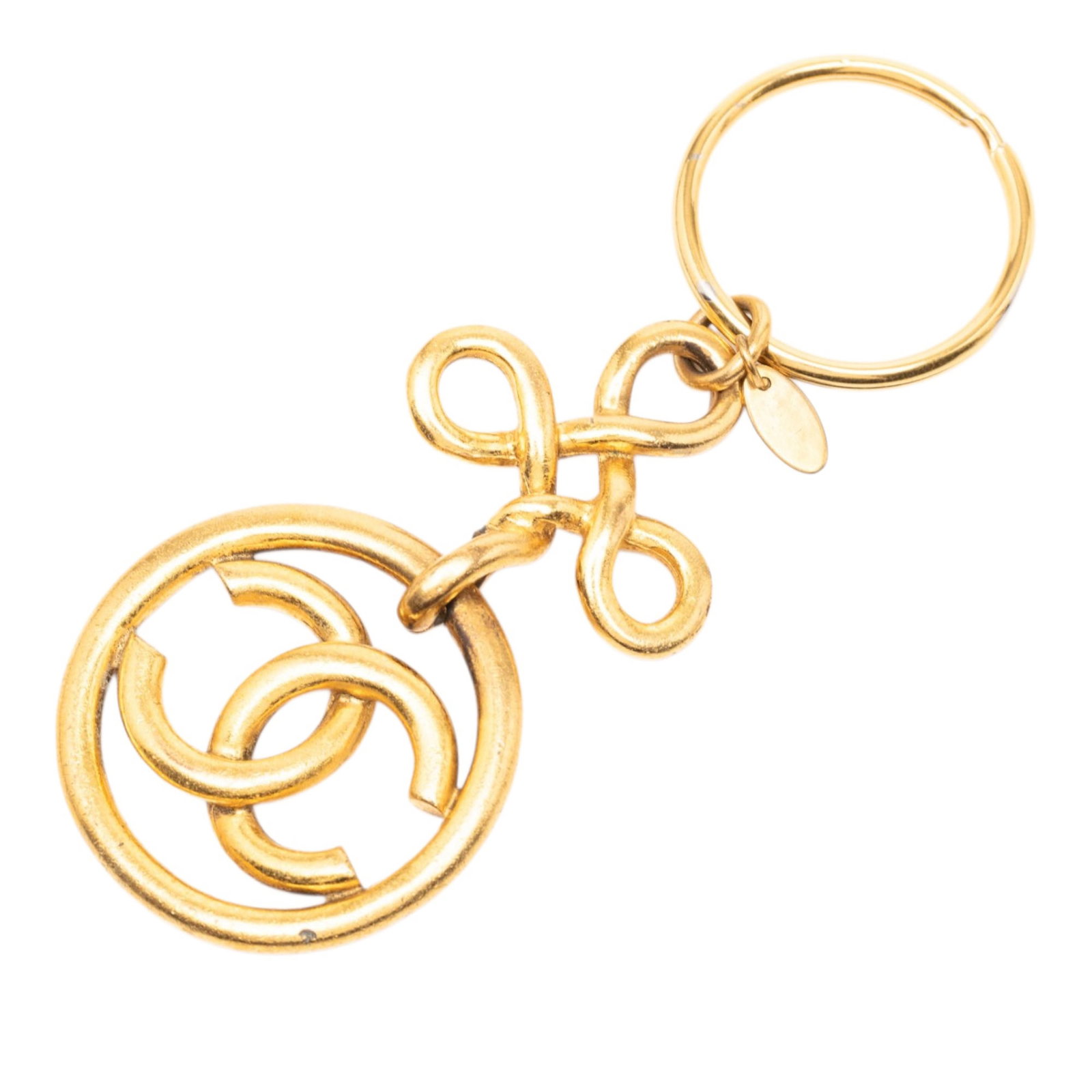 Chanel CC medallion key ring charm gold tone metal: Chanel CC medallion key ring charm gold tone metal This Chanel key ring bag charm features a gold-tone metal body with the iconic CC logo design, accented by a knot detail and a split ring closure. Ma