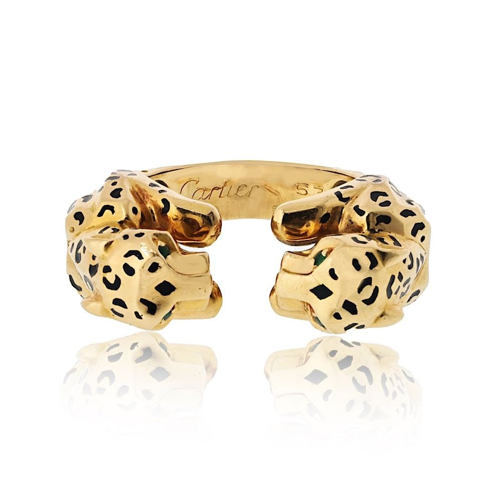Double Panther Motif 18K Gold Ring with Emerald Eyes by Cartier: Double Panther Motif 18K Gold Ring with Emerald Eyes by Cartier This estate Cartier ring features a striking double panther motif crafted in 18K yellow gold. The two panther heads are adorned with bol