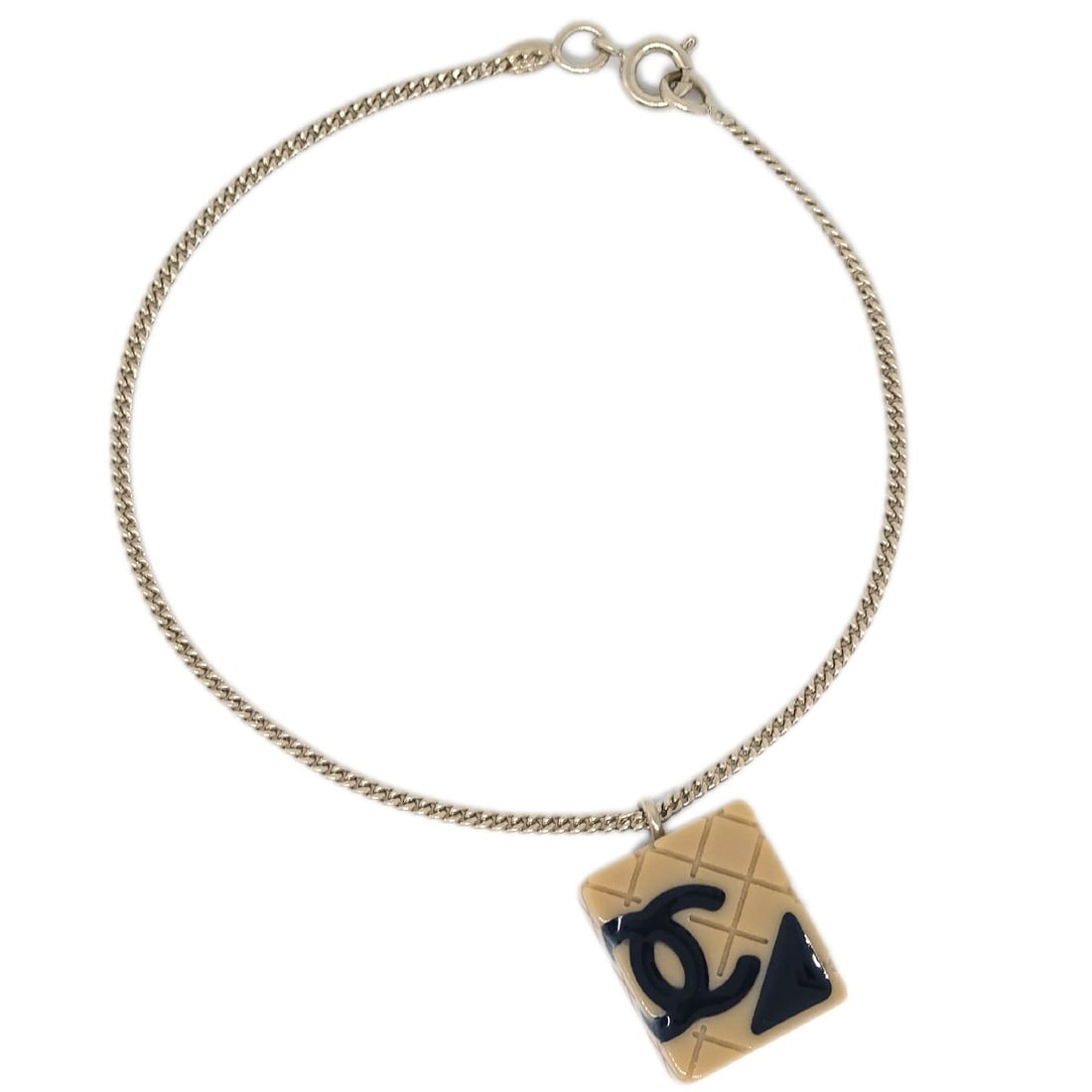 Chanel Cambon Ligne Gold Plated Bracelet 05C Beige Charm: Chanel Cambon Ligne Gold Plated Bracelet 05C Beige Charm Chanel Cambon Ligne bracelet in gold-plated metal with a gold and beige colorway. This bracelet features a charm detail and is marked 05C. Incl