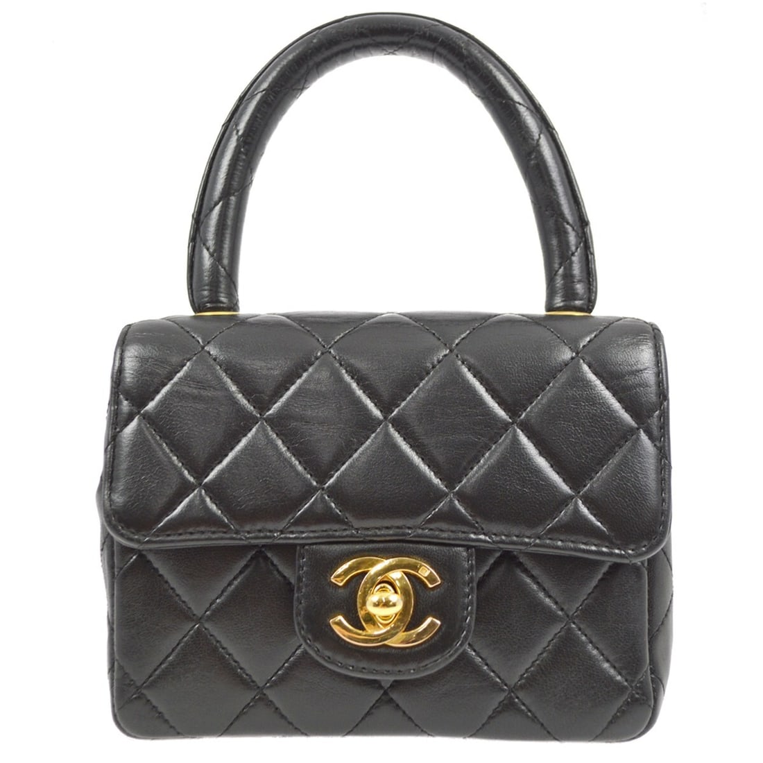 CHANEL Classic Flap Mini Top Handle Bag in Black Lambskin: CHANEL Classic Flap Mini Top Handle Bag in Black Lambskin Chanel Micro Classic Flap handbag in black lambskin leather with a matelasse quilted design and flap turn-lock closure. This women's top handl