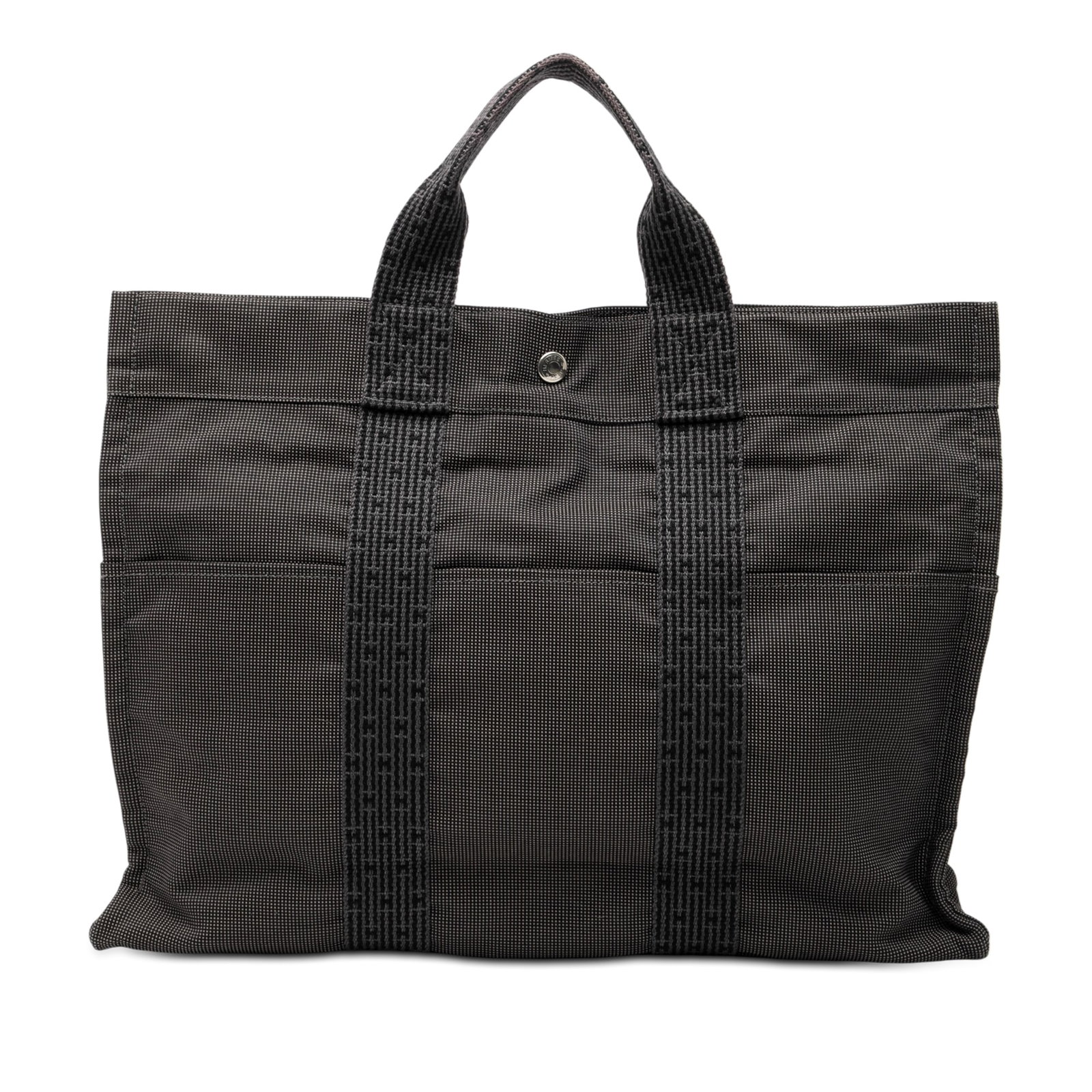 Hermes Herline MM gray canvas tote bag: Hermes Herline MM gray canvas tote bag The Hermes Herline MM is a gray canvas tote featuring flat handles, a top zip closure, and both exterior front and back slip pockets. The interior includes an ad