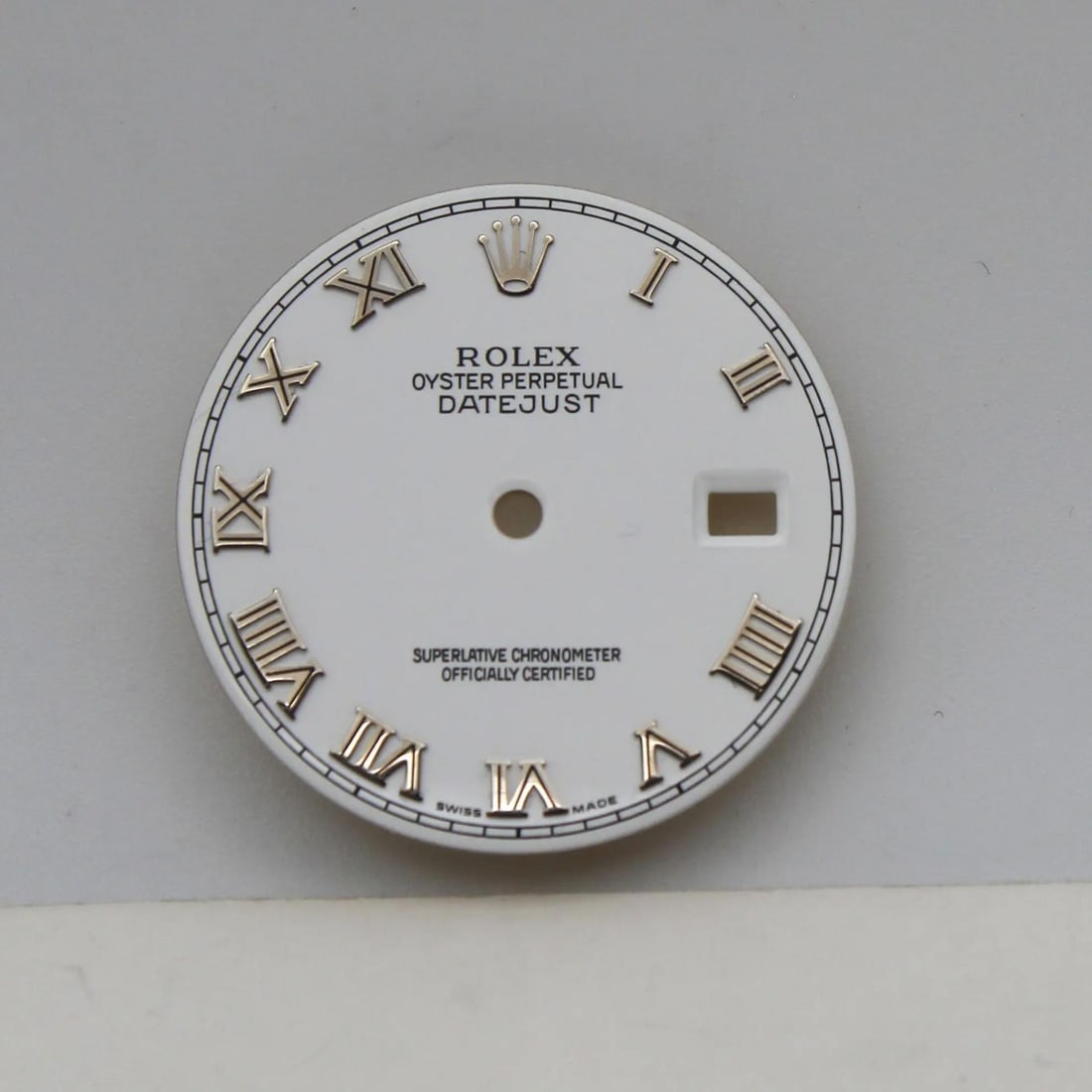 White Roman Numeral Dial for Rolex Oyster Perpetual Datejust 116234: White Roman Numeral Dial for Rolex Oyster Perpetual Datejust 116234 This is a pre-owned Rolex Oyster Perpetual Datejust dial featuring Roman numerals and a white color. The dial is designed for luxury
