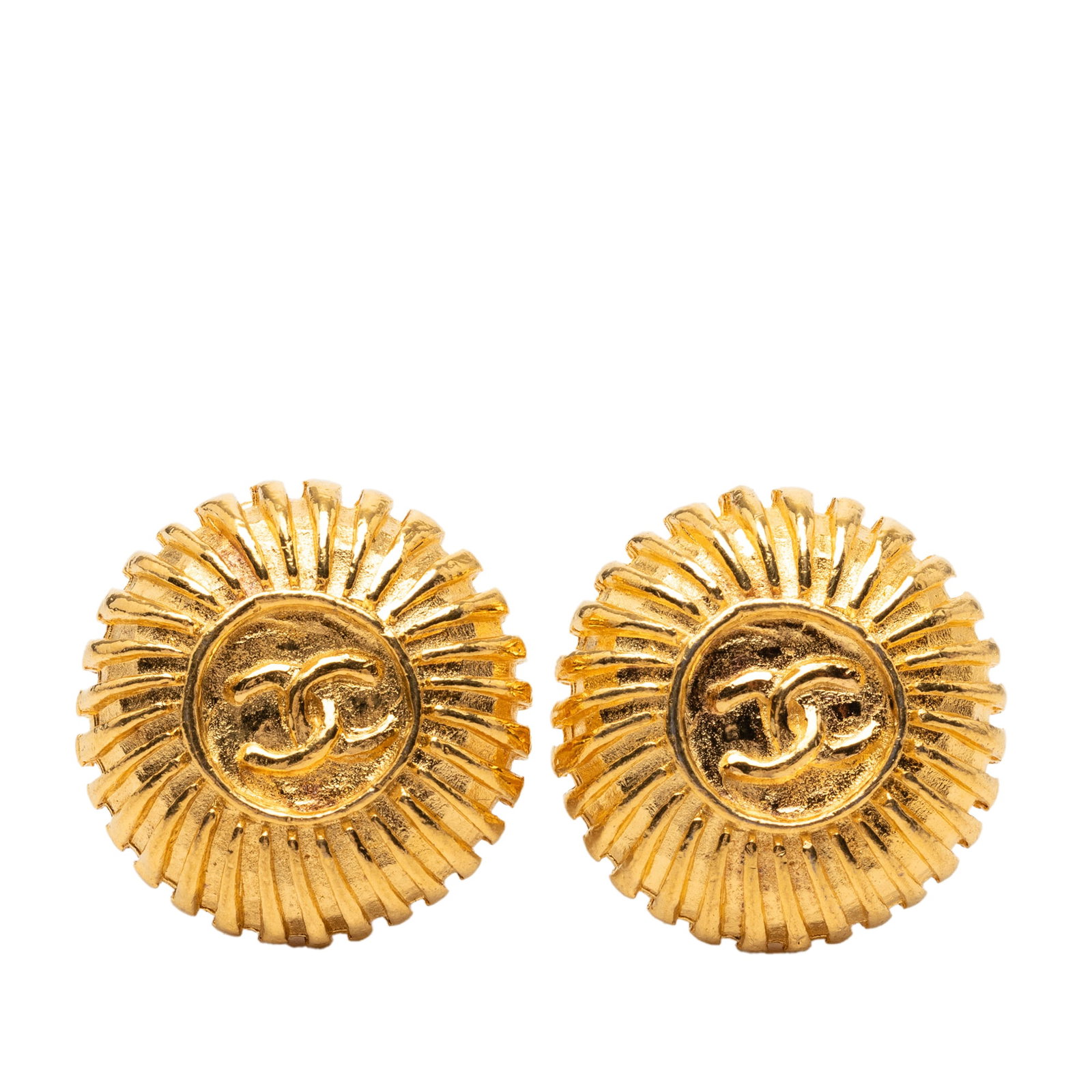 Chanel CC round clip on earrings gold plated: Chanel CC round clip on earrings gold plated These Chanel earrings feature a round design with gold tone metal bodies and back clip-on closures. They are crafted in France and display the iconic CC lo