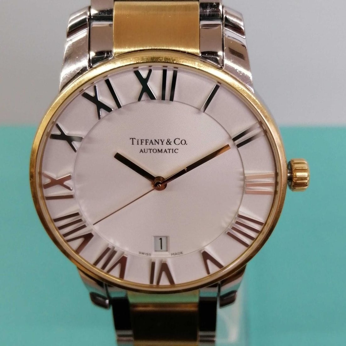 Tiffany Co Atlas Z1800.68 mens automatic wristwatch steel rose gold: Tiffany Co Atlas Z1800.68 mens automatic wristwatch steel rose gold Men's pre-owned wristwatch from the ATLAS line, model Z1800.68. It features a stainless steel case and band, automatic movement, and