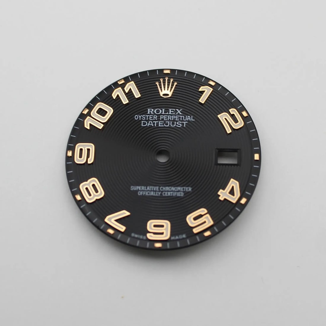 Black Concentric Dial with Arabic Numbers for Rolex Datejust 116231 36MM: Black Concentric Dial with Arabic Numbers for Rolex Datejust 116231 36MM This is a pre-owned Rolex Datejust dial designed for the 36mm model 116231. The dial features a black concentric pattern with A