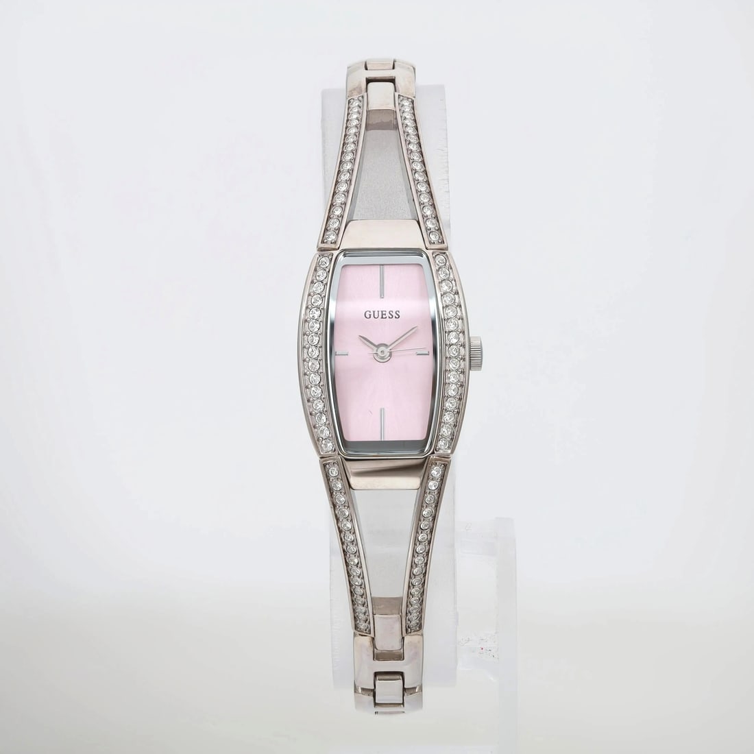 GUESS Hourglass 18mm Quartz Ladies Watch Pink Dial Gem-Set Bezel: GUESS Hourglass 18mm Quartz Ladies Watch Pink Dial Gem-Set Bezel This stunning Guess Hourglass wristwatch features a stylish pink sunburst dial that adds a vibrant touch to any formal outfit. The watc