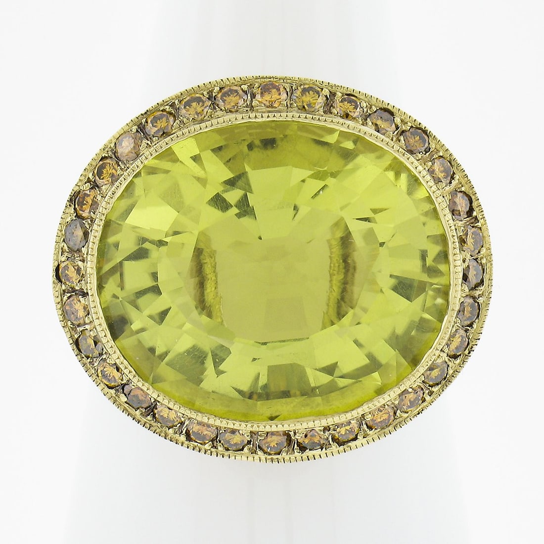 18k Yellow Gold GIA Certified Oval Lemon Quartz Diamond Halo Ring: 18k Yellow Gold GIA Certified Oval Lemon Quartz Diamond Halo Ring This exquisite cocktail ring showcases a stunning natural lemon quartz at its center, beautifully set in solid 18k yellow gold. The ov