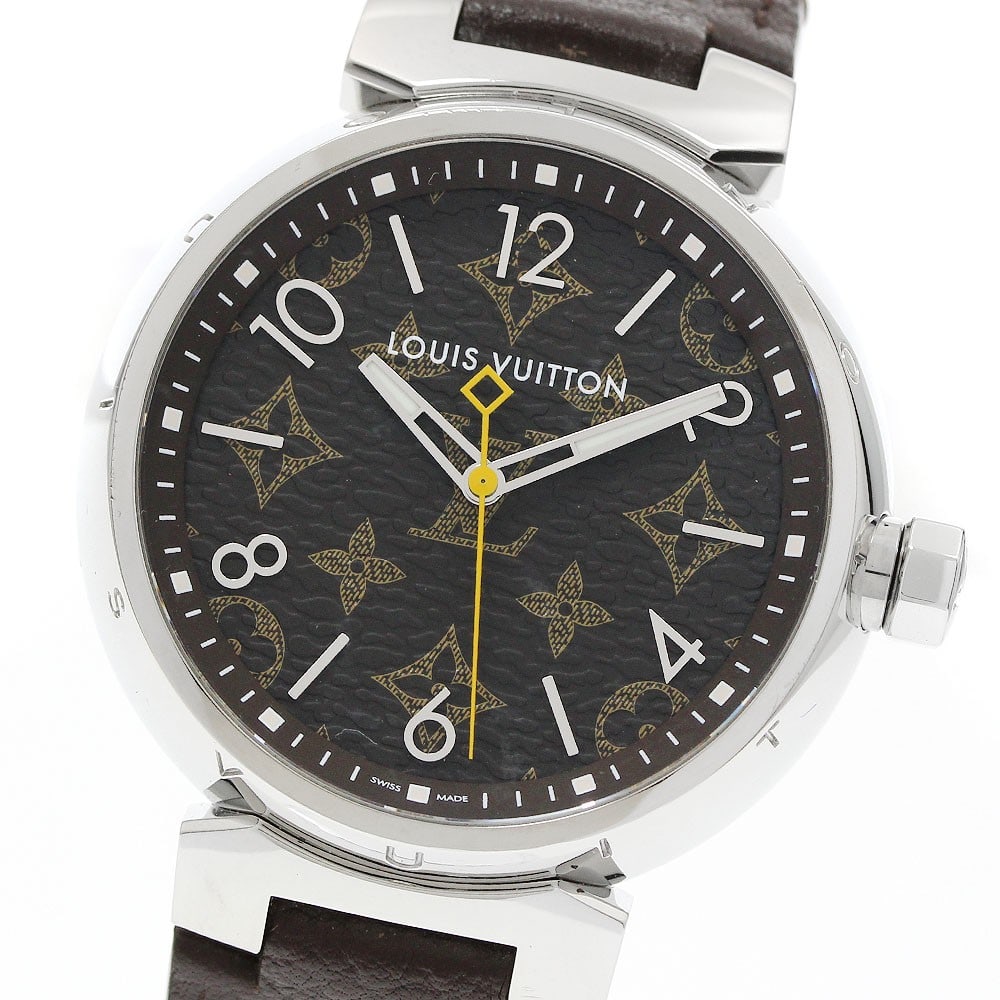 Louis Vuitton Tambour QA072 mens quartz wristwatch: Louis Vuitton Tambour QA072 mens quartz wristwatch A pre-owned Louis Vuitton Tambour men's wristwatch with a quartz movement. It features a stainless steel case, brown dial, and leather belt. The watc