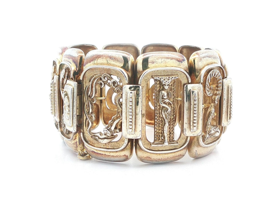 Erte vermeil silver wide bangle bracelet with safety chain: Erte vermeil silver wide bangle bracelet with safety chain This vintage wide bracelet features a design inspired by Romain de Tirtoff (Erte) and is crafted from solid vermeil silver. The bracelet has 