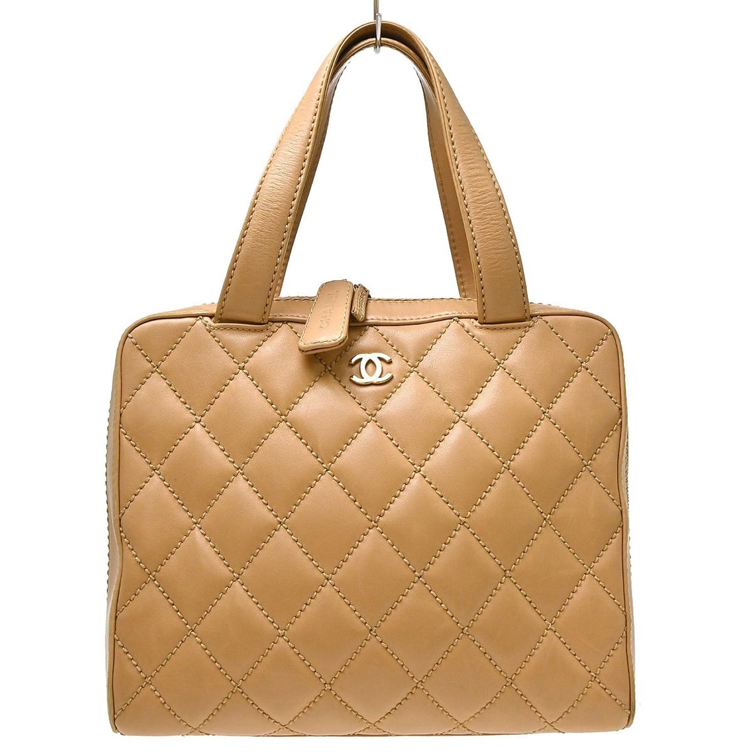 CHANEL Wild Stitch Beige Calfskin Leather Top Handle Bag: CHANEL Wild Stitch Beige Calfskin Leather Top Handle Bag Chanel Wild Stitch handbag in beige calfskin leather with a quilted exterior, top handle, and zip closure. It is a medium-sized women's bag wit