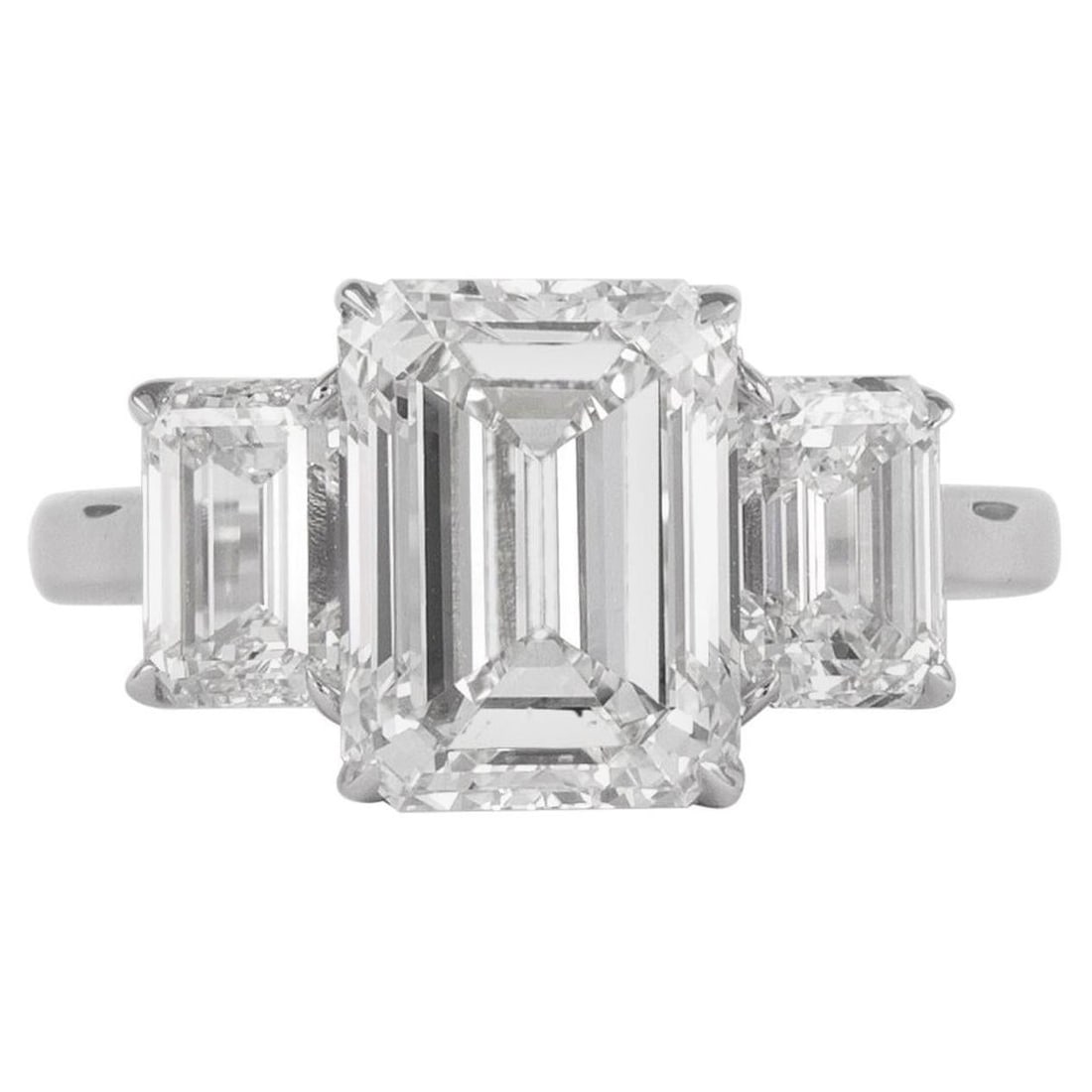 GIA 4.01ct Emerald Cut Diamond Ring 18k White Gold: GIA 4.01ct Emerald Cut Diamond Ring 18k White Gold This exquisite three-stone diamond ring features a stunning 4.01ct emerald cut diamond at its center, complemented by two additional emerald cut diam
