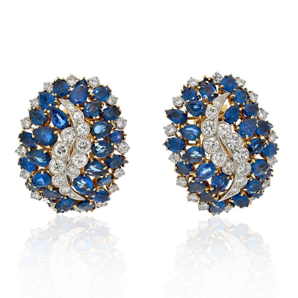 Sapphire and Diamond Clip Earrings in Platinum and 18K Gold by David Webb: Sapphire and Diamond Clip Earrings in Platinum and 18K Gold by David Webb These David Webb earrings are crafted from platinum and 18K yellow gold, featuring transparent deep blue sapphires and white, 