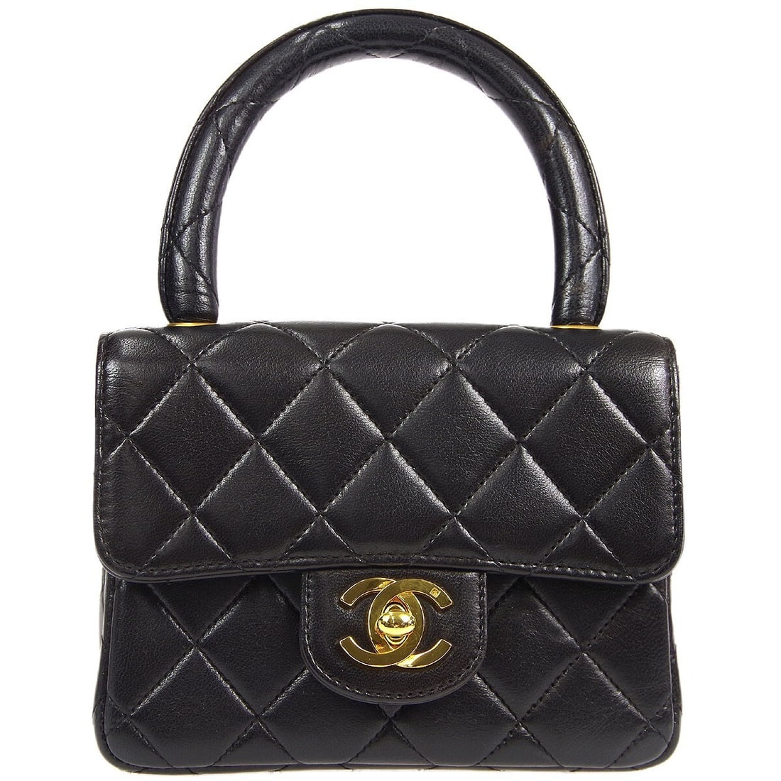 Chanel Classic Flap Mini Top Handle Bag in Black Lambskin: Chanel Classic Flap Mini Top Handle Bag in Black Lambskin Chanel Classic Flap micro handbag in black quilted lambskin leather with a flap turn-lock closure and top handle. The bag features one exterio
