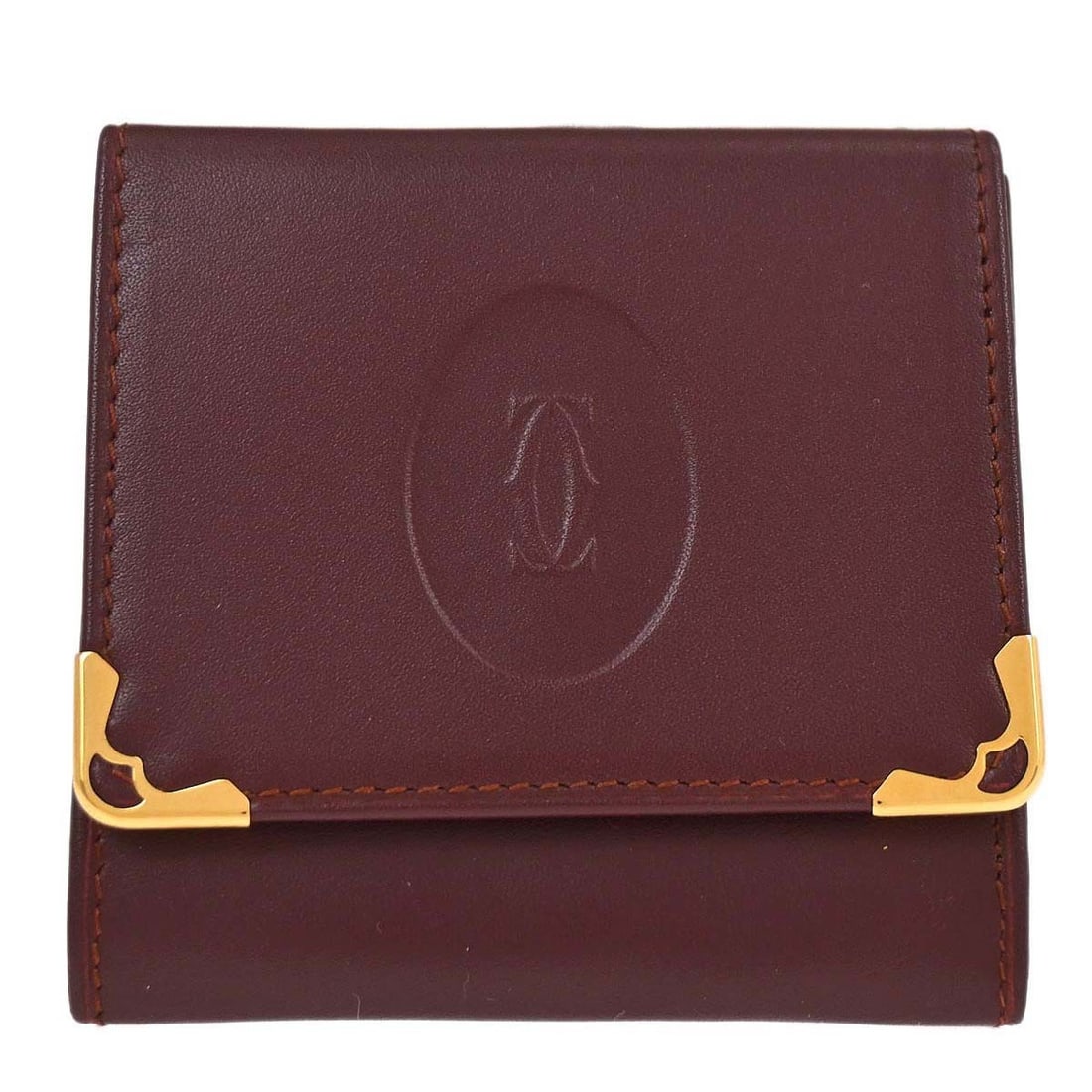 Cartier Must de Cartier leather coin wallet in Bordeaux: Cartier Must de Cartier leather coin wallet in Bordeaux Must de Cartier coin purse wallet in bordeaux leather with logo accenting. This women's wallet features one exterior pocket and one interior poc