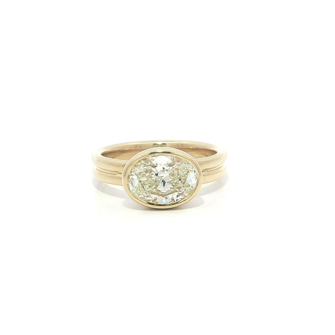 2ct M SI2 Oval Diamond Solitaire Band in 18k Yellow Gold with GIA Certification: 2ct M SI2 Oval Diamond Solitaire Band in 18k Yellow Gold with GIA Certification This un-used band-style ring features a 2.00 carat natural oval brilliant cut diamond set in a bezel setting. The diamon