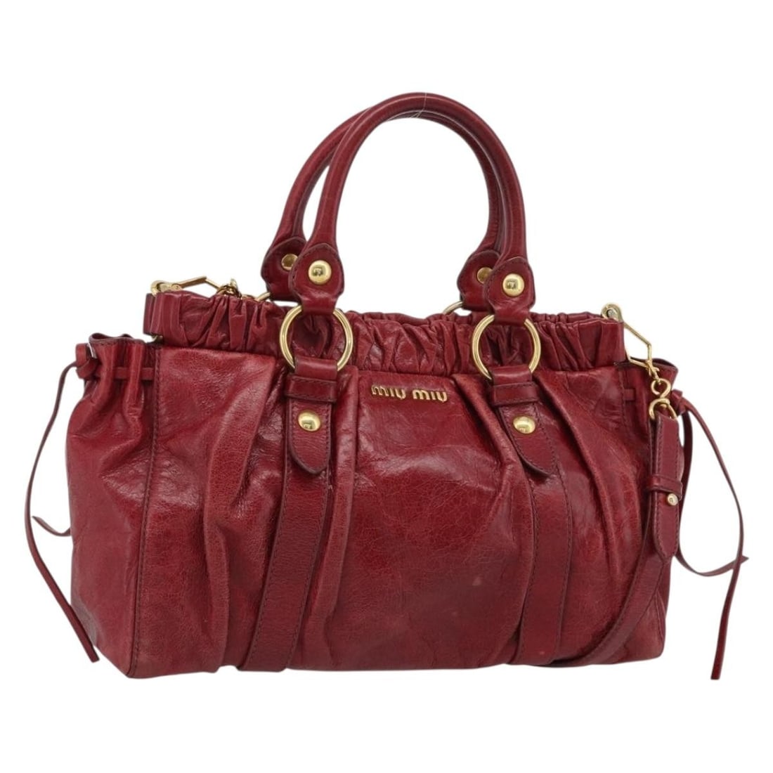 Miu Miu Red Leather 2 Way Handbag with Shoulder Strap: Miu Miu Red Leather 2 Way Handbag with Shoulder Strap Miu Miu hand bag in leather with a red and gold color scheme, made in Italy. It comes with a shoulder strap and features a structured size of appr
