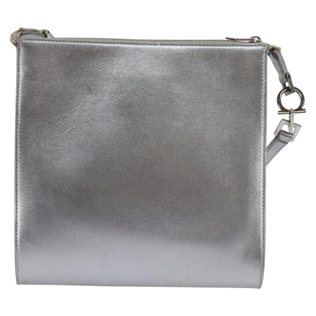 Salvatore Ferragamo Gancini Silver Leather Shoulder Bag: Salvatore Ferragamo Gancini Silver Leather Shoulder Bag This Salvatore Ferragamo Gancini shoulder bag for women features silver leather construction with a compact design. The bag shows signs of surfa