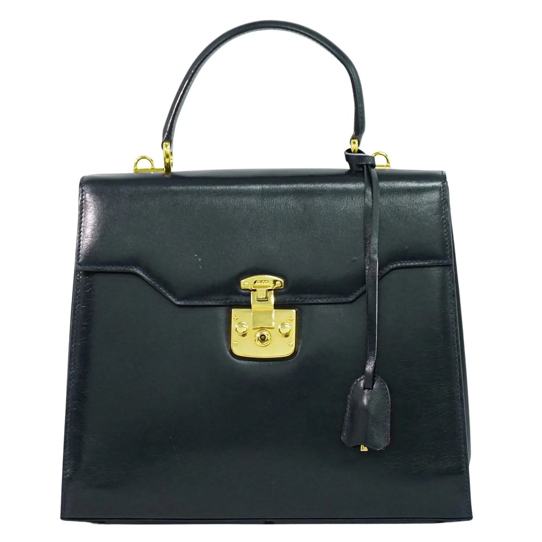 Gucci Navy Leather Vintage Lady Lock Top Handle Purse: Gucci Navy Leather Vintage Lady Lock Top Handle Purse This vintage Gucci Lady Lock top handle bag for women features navy leather construction with a classic design. The bag shows signs of wear includ