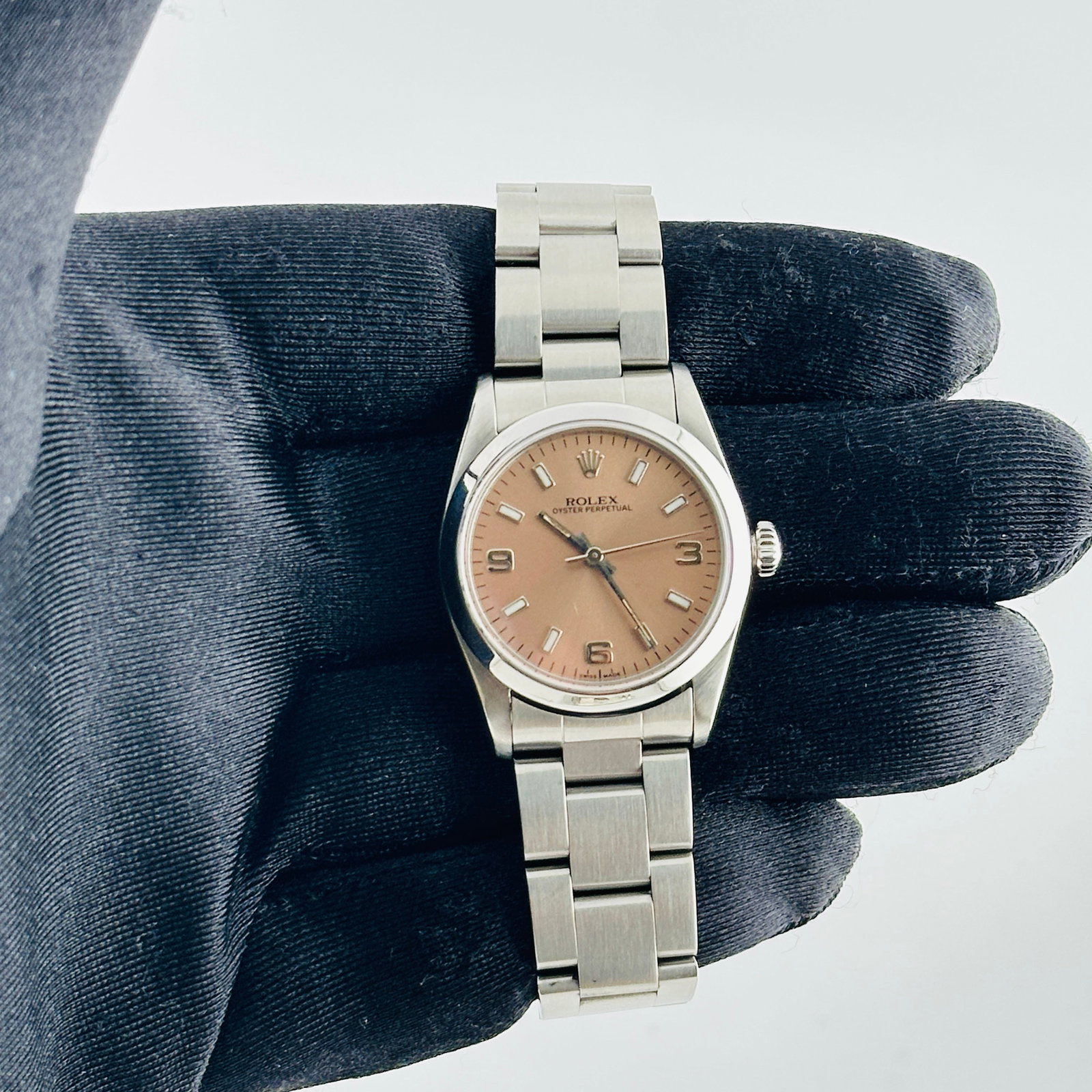 Ladies Rolex Oyster Perpetual Ref 67480 Salmon Dial with Oyster Bracelet: Ladies Rolex Oyster Perpetual Ref 67480 Salmon Dial with Oyster Bracelet This ladies Rolex Oyster Perpetual features an Aftermarket lavender dial and a smooth bezel, complemented by an Oyster bracelet