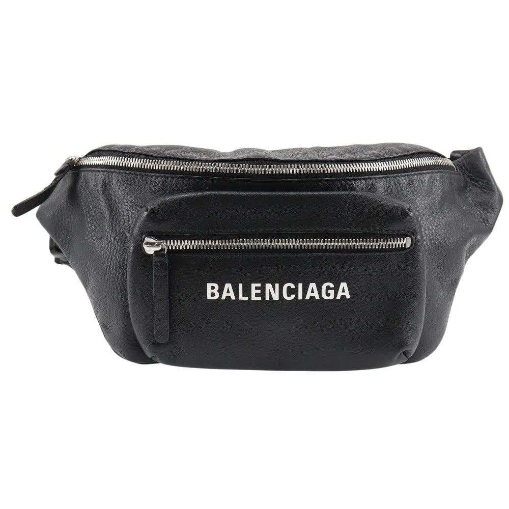 Black Leather Everyday Waist Bag by Balenciaga: Black Leather Everyday Waist Bag by Balenciaga This Balenciaga Everyday Waist Bag is crafted from black leather and designed for unisex use. Made in Italy, it features a sleek silhouette and practical