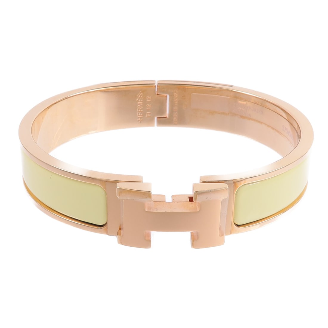 Hermes Clic H Enamel Metal Bracelet Yellow Gold Tone: Hermes Clic H Enamel Metal Bracelet Yellow Gold Tone Hermes Clic H bracelet in yellow enamel and metal with a gold finish. It comes with storage box and storage bags. Condition is AB: Very Good. Speci