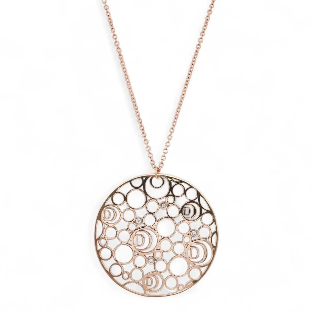 Damiani 18K Rose Gold Diamond Pendant Necklace with Logo D Motifs: Damiani 18K Rose Gold Diamond Pendant Necklace with Logo D Motifs Experience the elegance of this Damiani Damianissima Diamond Round Cutout Pendant Necklace, meticulously crafted in Italy from 18K ros