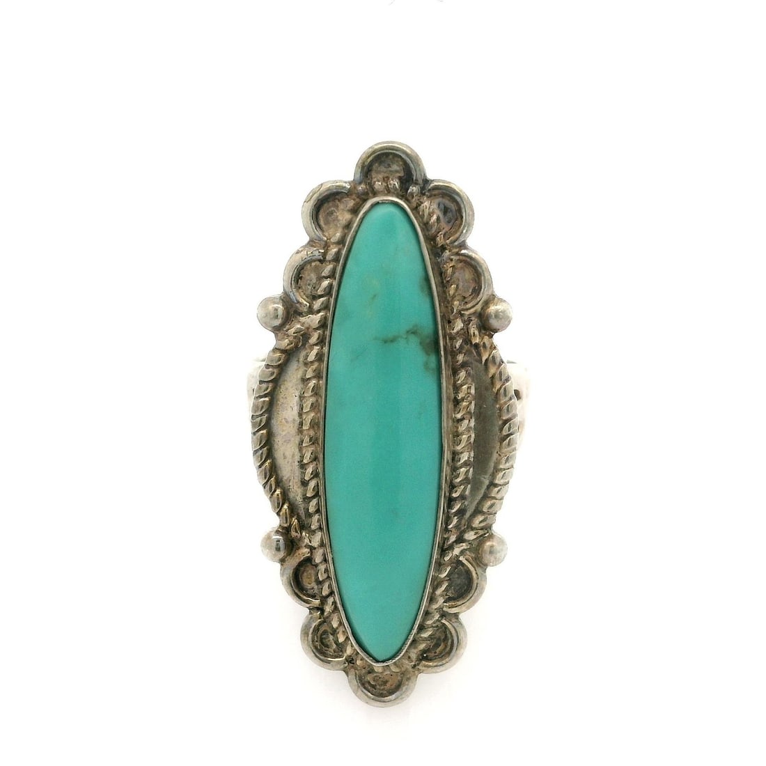 Navajo Sterling Silver Turquoise Cocktail Ring with Twisted Wire Detail: Navajo Sterling Silver Turquoise Cocktail Ring with Twisted Wire Detail This exquisite cocktail ring showcases a stunning elongated navette design, featuring a natural genuine turquoise cabochon. The 