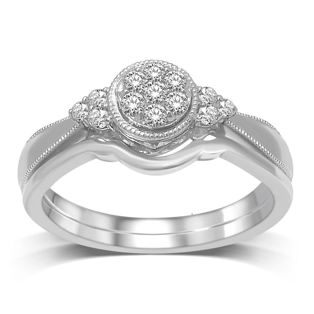 10K White Gold 1/5 Ct.tw Diamond Bridal Ring: 10K White Gold 1/5 Ct.tw Diamond Bridal Ring This eye-catching Bridal Ring is available in 10K White Gold. There is 1 round diamond with a total carat weight of 1/5 Ct.Tw. set in a shared prong settin