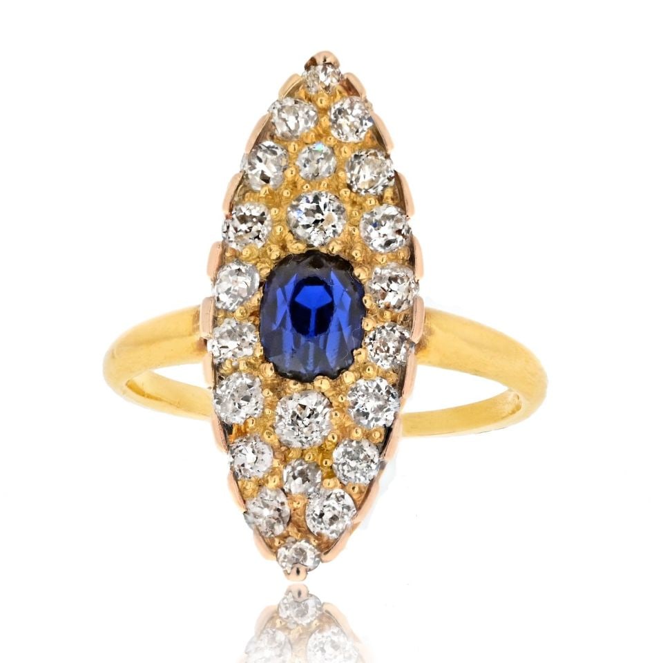 Tiffany & Co. 14K Yellow Gold Burma Sapphire Diamond Navette Ring: Tiffany & Co. 14K Yellow Gold Burma Sapphire Diamond Navette Ring This exquisite Tiffany & Co. estate ring features a stunning navette shape, showcasing a cushion cut Burma sapphire at its center. The