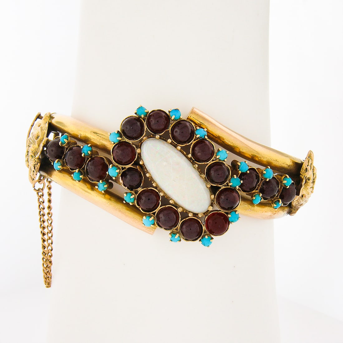 Handmade 14k Yellow Gold Opal Garnet Turquoise Bangle Bracelet: Handmade 14k Yellow Gold Opal Garnet Turquoise Bangle Bracelet This exquisite handmade 14k yellow gold bangle bracelet features a striking elongated oval cabochon cut natural opal at its center, surro