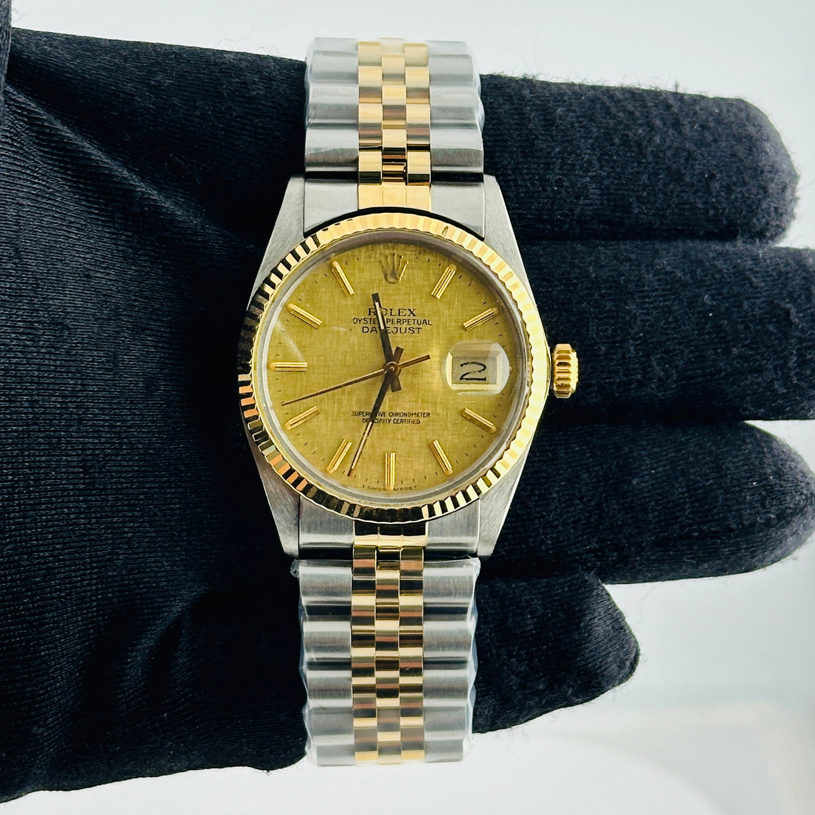 Rolex Datejust 16013 Champagne Linen Stick Dial Aftermarket Jubilee Bracelet: Rolex Datejust 16013 Champagne Linen Stick Dial Aftermarket Jubilee Bracelet This men's Rolex Datejust features a champagne linen stick dial and a fluted bezel, paired with an aftermarket Jubilee brac