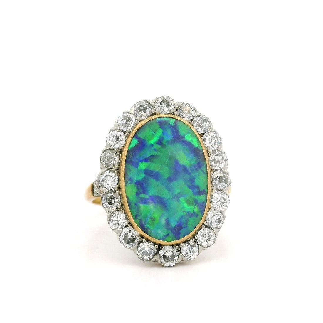 Antique Edwardian Gold Platinum GIA Black Opal Diamond Halo Ring: Antique Edwardian Gold Platinum GIA Black Opal Diamond Halo Ring This exquisite Antique Edwardian ring features a stunning natural black opal at its center, showcasing a mesmerizing harlequin pattern 