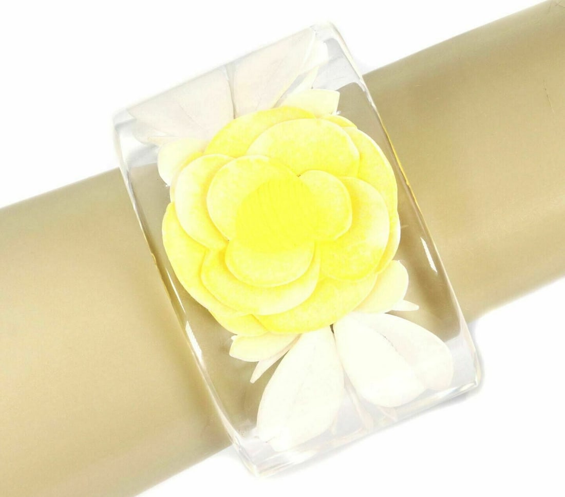 Chanel clear lucite resin cuff bracelet with flower motif: Chanel clear lucite resin cuff bracelet with flower motif Vintage Chanel cuff bracelet crafted from clear lucite and resin, featuring a bold wide silhouette with a floral motif. The transparent sculpt
