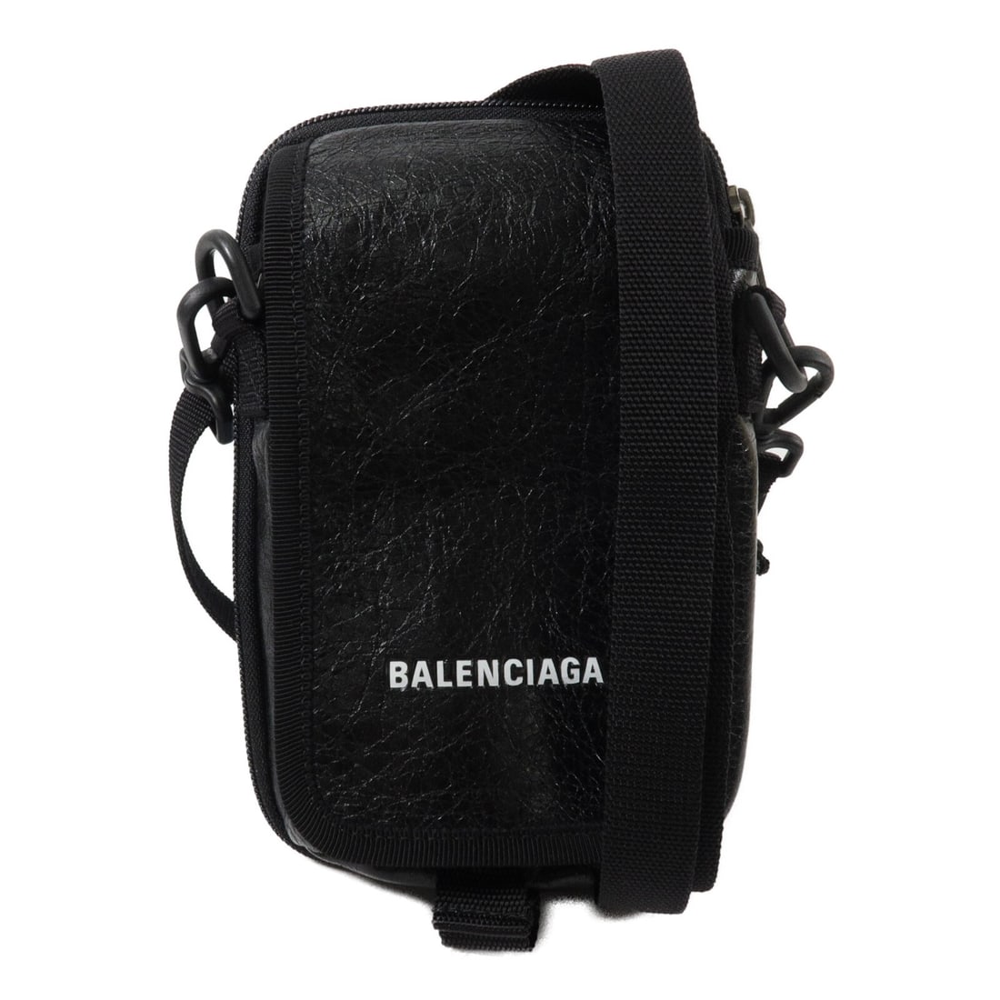 Balenciaga 593329 calfskin shoulder bag in black: Balenciaga 593329 calfskin shoulder bag in black Black shoulder bag made from calfskin (cowhide), identified as model 593329. It features a flap closure, multiple pockets, and comes with a storage bag