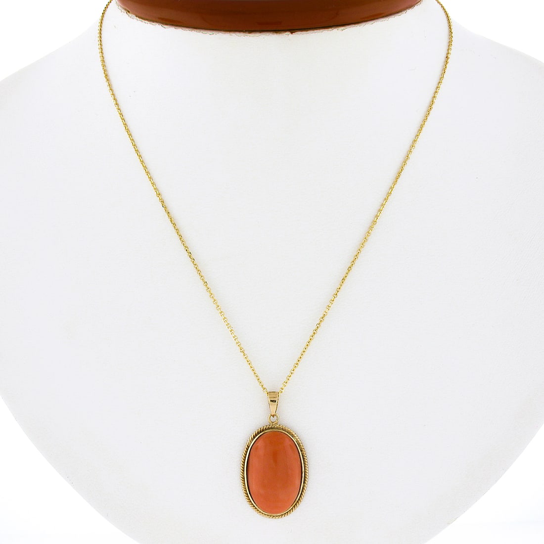 Vintage 14k Yellow Gold Twisted Frame Pink Coral Pendant with Adjustable Chain: Vintage 14k Yellow Gold Twisted Frame Pink Coral Pendant with Adjustable Chain This exquisite vintage pendant is crafted from solid 14k yellow gold and features a stunning elongated oval cabochon cut 