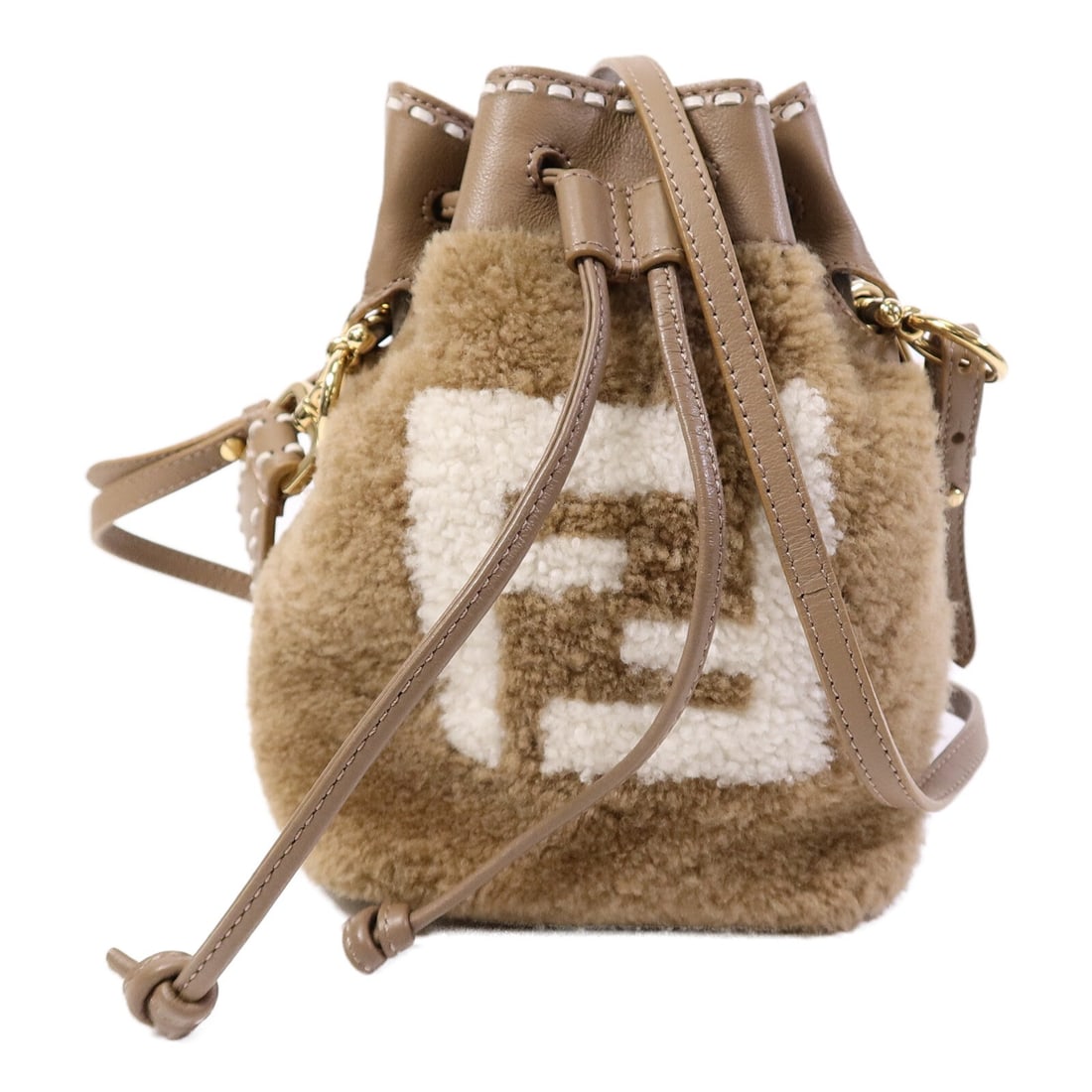 Fendi Mini Mon Tresor Shearling Bucket Bag 8BS010 AHVU Brown: Fendi Mini Mon Tresor Shearling Bucket Bag 8BS010 AHVU Brown A Fendi Mini Mon Tresor 2-way shoulder bag in brown shearling. This model features a removable hand strap and comes with a shoulder strap. 