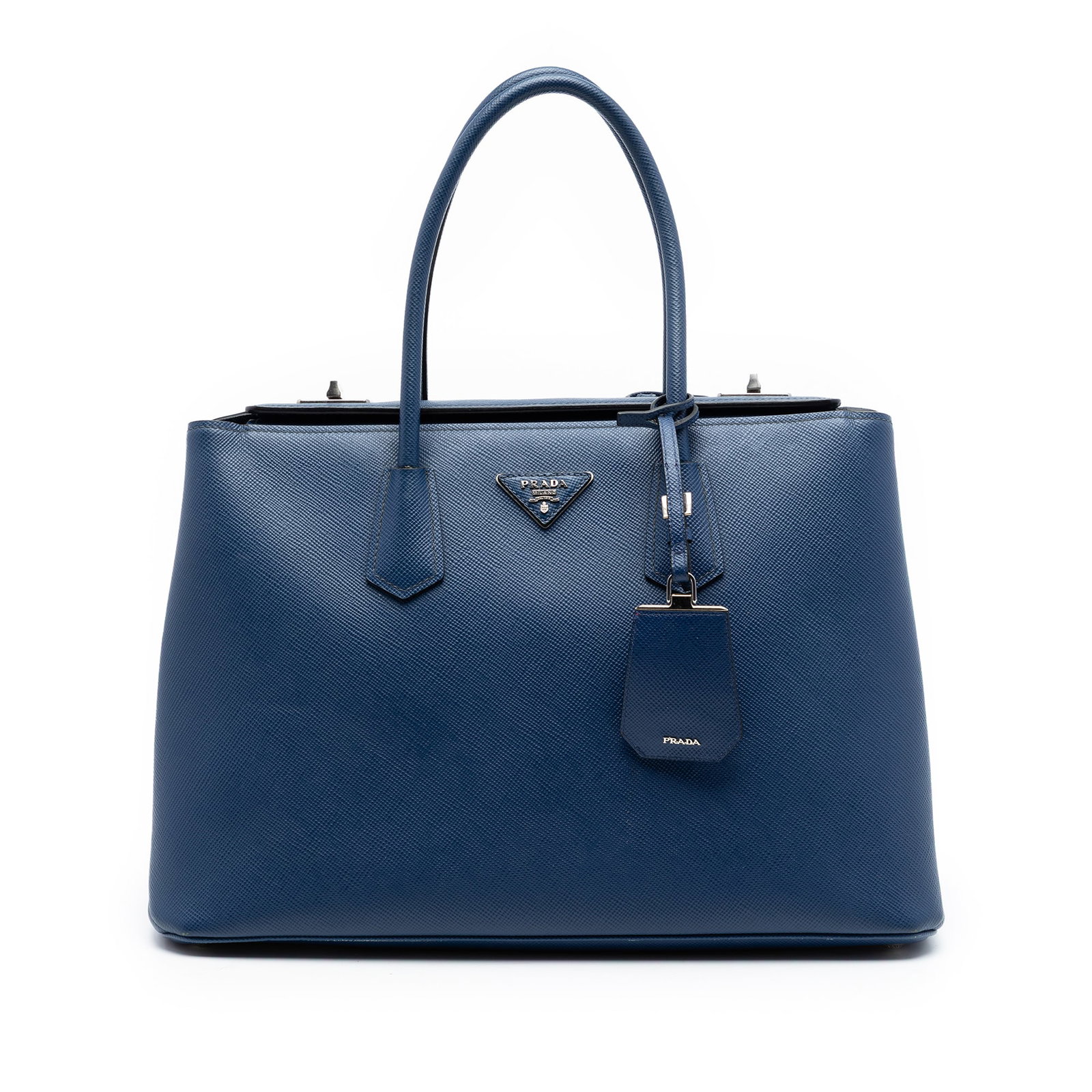 Prada Saffiano Cuir Twin Turnlock Leather Satchel Blue: Prada Saffiano Cuir Twin Turnlock Leather Satchel Blue Prada Saffiano Cuir Turnlock Twin Satchel in blue leather, made in Italy. It features a saffiano leather body, rolled leather handles, a fold-ove
