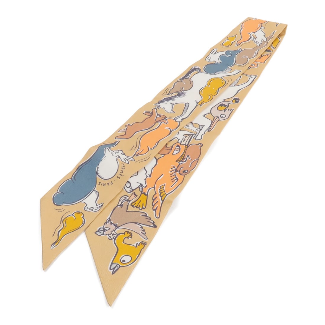 Hermes Twilly Silk Scarf Brown Orange 86cm x 5cm: Hermes Twilly Silk Scarf Brown Orange 86cm x 5cm Hermes Twilly scarf in silk with a brown and orange color combination. It is a women's regular-size scarf made in France and is offered in very good AB